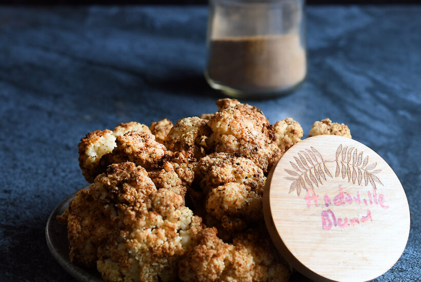 Air Fried Andouille Cauliflower on a blue ceramic plate